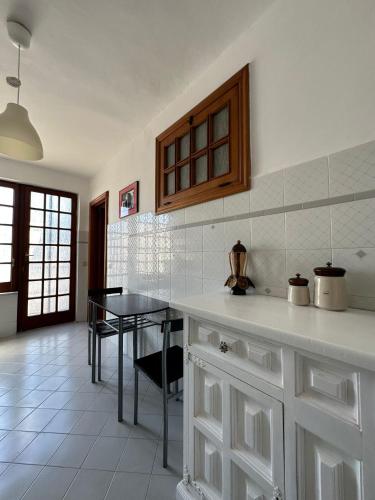 a kitchen with a counter and a table in it at Casa Paolina - casa vacanze in Capri