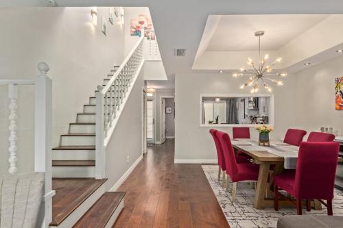 a dining room and kitchen with a dining table and red chairs at Resort Style Living In Phoenix's Most Exclusive Gated Community! in Phoenix