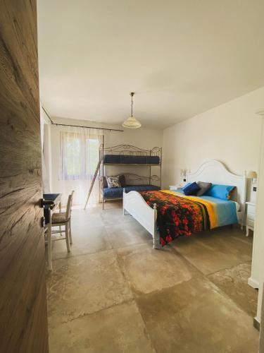 a bedroom with a bed and a table and chairs at Agriturismo Villa Tadina in Gualdo Tadino