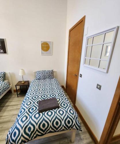 a bedroom with a bed and a window and a door at Imperial House Sea View Margate in Kent