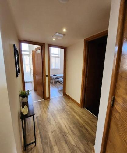 an empty room with a hallway with wooden floors at Imperial House Sea View Margate in Kent