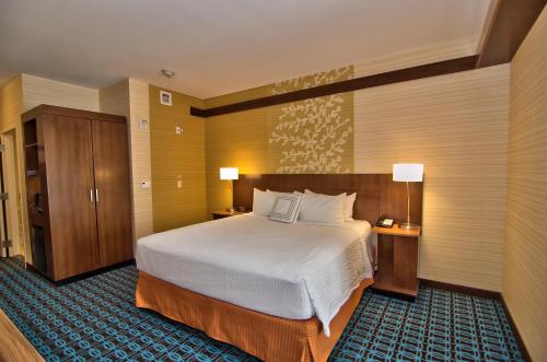 a hotel room with a large bed and two lamps at Fairfield Inn & Suites by Marriott Towanda Wysox in Towanda