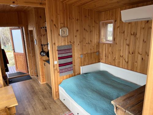a bedroom with a bed in a wooden room at Near Golden Circle-10 sleeps in Selfoss