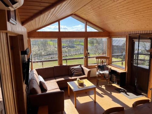 a living room with a couch and a table at Near Golden Circle-10 sleeps in Selfoss