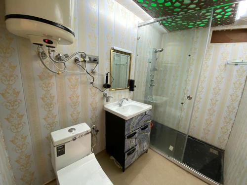 a bathroom with a toilet and a sink and a shower at Luxury Egypt Group of House Boat in Srinagar