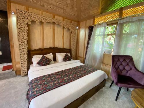 a bedroom with a large bed and a chair at Luxury Egypt Group of House Boat in Srinagar