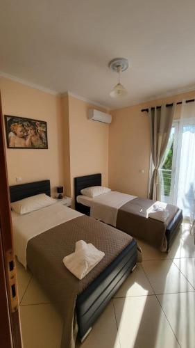 a bedroom with two beds and a window at Markulata in Khalikerí