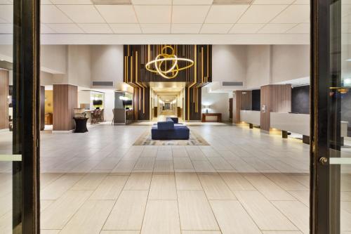 a lobby with a blue couch in the middle at Crowne Plaza Dulles Airport by IHG in Herndon
