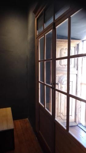 an open window with a view of a building at Casa Tunki in Cusco