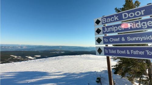 a sign at the top of a snow covered mountain at Kookaburra Lodge #401 By Bear Country in Sun Peaks