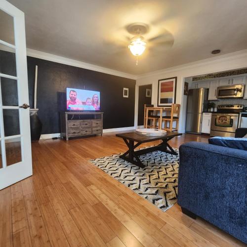 a living room with a couch and a table and a tv at Cozy View Downtown Atlanta Condo in Atlanta