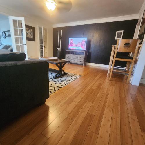 a living room with a couch and a table and a tv at Cozy View Downtown Atlanta Condo in Atlanta