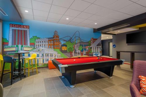 a room with a pool table and a mural at Tru By Hilton Ashland, Va in Ashland