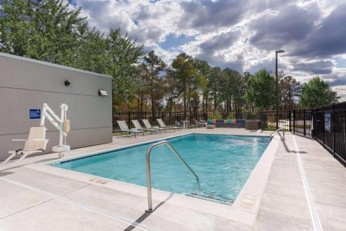 a swimming pool with lounge chairs at Tru By Hilton Ashland, Va in Ashland