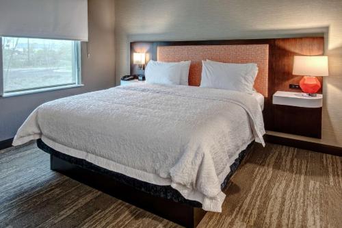ein Schlafzimmer mit einem großen Bett und einem Fenster in der Unterkunft Hampton Inn & Suites Culpeper in Culpeper