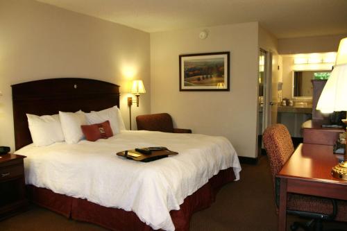 a hotel room with a bed with a tray on it at Hampton Inn Dalton in Dalton