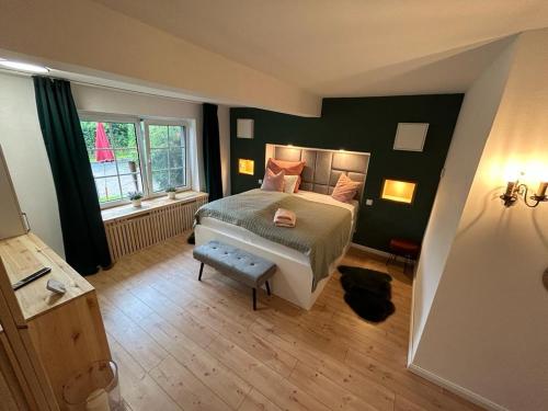 a bedroom with a large bed and a window at Appartement fliegender Hirsch in Bäk