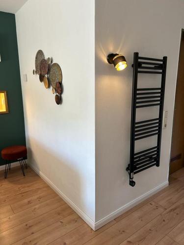 a room with a wall with a shelf and a light at Appartement fliegender Hirsch in Bäk