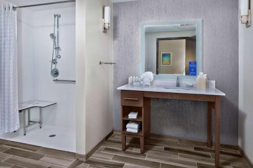 a bathroom with a sink and a shower at Homewood Suites By Hilton Greensboro Wendover, Nc in Greensboro