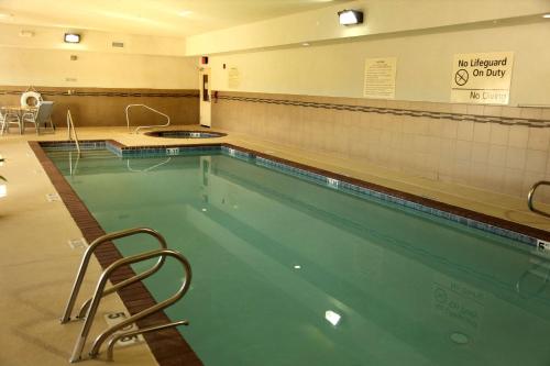 a swimming pool with a chair next to it at Hampton Inn & Suites Carlsbad in Carlsbad