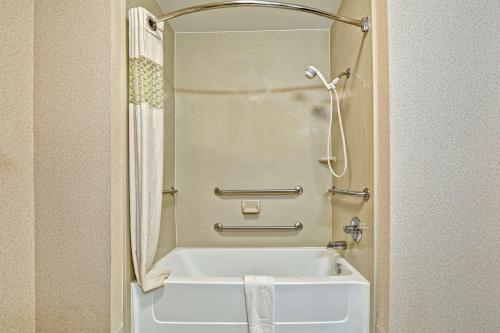 a small bathroom with a tub and a shower at Hampton Inn Quincy in Quincy