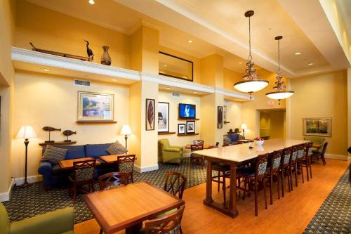 a living room with tables and chairs and a couch at Hampton Inn & Suites Lake Wales in Lake Wales