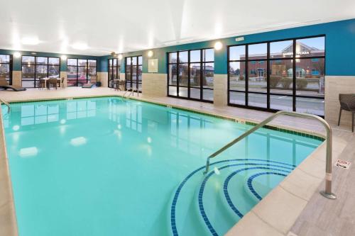 a large pool with blue water in a building at Hampton Inn Middletown in Middletown