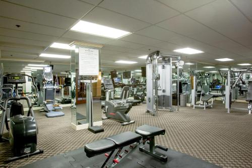 a gym with a lot of treadmills and machines at The Townsend Hotel in Birmingham