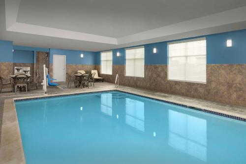 a large swimming pool in a room with blue walls at Hampton Inn Augusta in Augusta