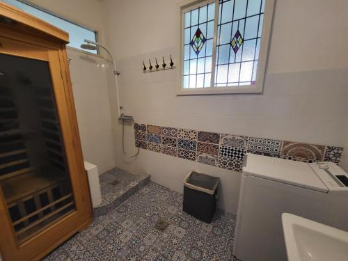 a bathroom with a sink and a window and a toilet at Sunny Panorama Flat near Castle with balcony in Budapest