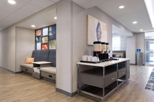 a lobby with a couch and a table with bottles of wine at Hampton Inn & Suites St Charles Old Town Area, Mo in St. Charles