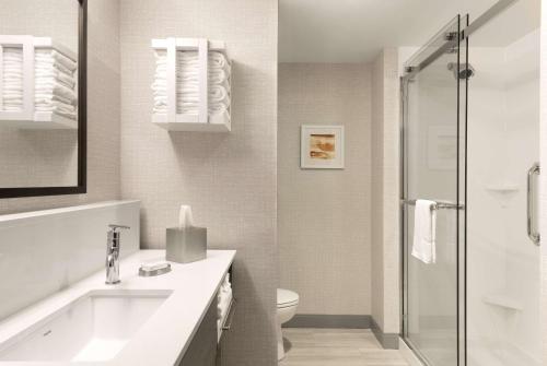 a white bathroom with a shower and a toilet at Hampton Inn & Suites St Charles Old Town Area, Mo in St. Charles