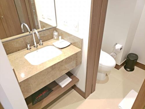 a bathroom with a sink and a toilet at Hampton By Hilton Bucaramanga in Bucaramanga