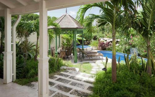 a garden with a gazebo and a swimming pool at Hilton Grand Vacations Club The Crane Barbados in Saint Philip