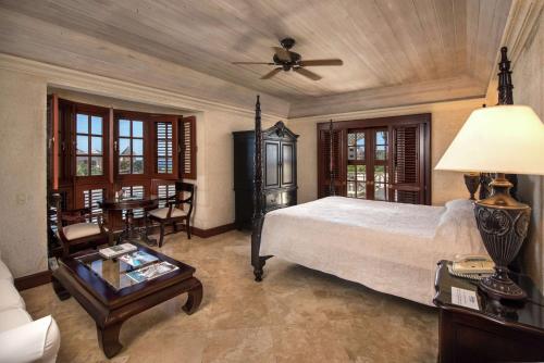 a bedroom with a bed and a table and chairs at Hilton Grand Vacations Club The Crane Barbados in Saint Philip