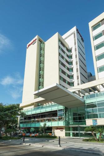 a large white building with a lot of windows at Hampton by Hilton Barranquilla in Barranquilla