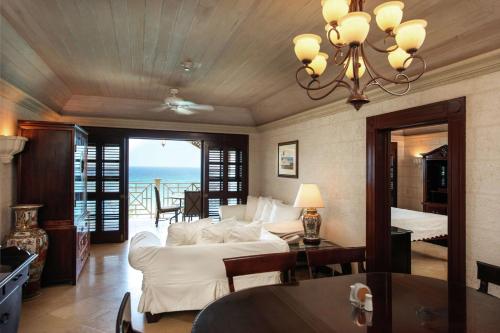 a living room with a white couch and a table at Hilton Grand Vacations Club The Crane Barbados in Saint Philip