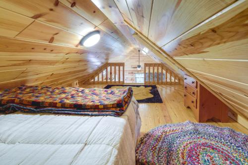 a bedroom with a bed in a wooden cabin at Marlinton Cabin Rental with Greenbrier River Access! in Marlinton