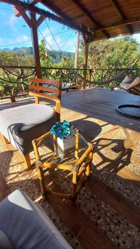 a glass table sitting on a patio with a chair at El Guayabal de Mindo in Mindo