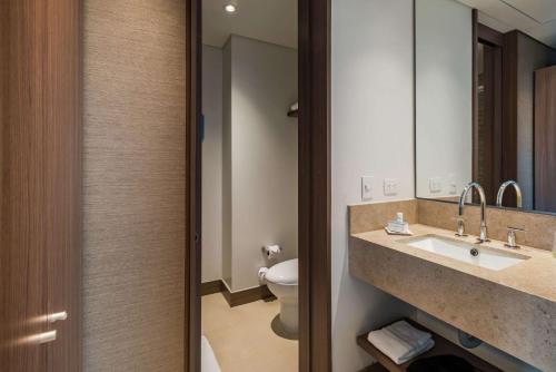 a bathroom with a sink and a toilet at Hampton By Hilton Bogota Airport in Bogotá
