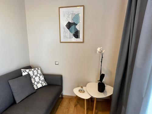 a living room with a couch and a table at AMMOS Beach apartment in Sidari