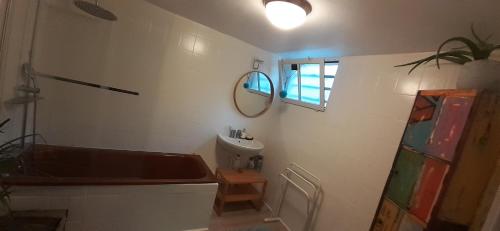 a bathroom with a tub and a sink and a mirror at MAISON VUE MAGISTRALE SUR LE PORT ET CALANQUES DES GOUDES MARSEILLE in Marseille