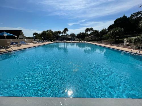 a large swimming pool with blue water at Watch the Sunrise on Lake Louisa in Clermont