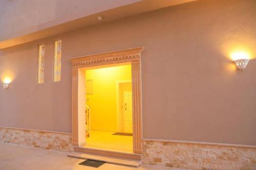 a hallway with a yellow door in a room at Royal Nile Villa - Nile View Apartment 1 in Luxor