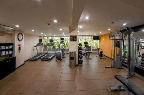 a gym with treadmills and machines in a room at Hilton Garden Inn Guatemala City in Guatemala