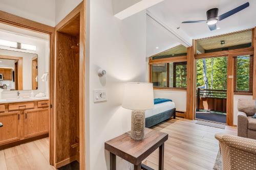 a room with a bed and a table with a lamp at Laurelwood Condominiums 211 in Snowmass Village