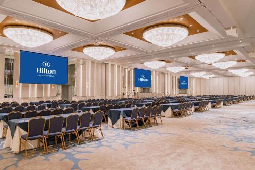 a conference room with rows of chairs and a stage at Hilton Colon Guayaquil Hotel in Guayaquil
