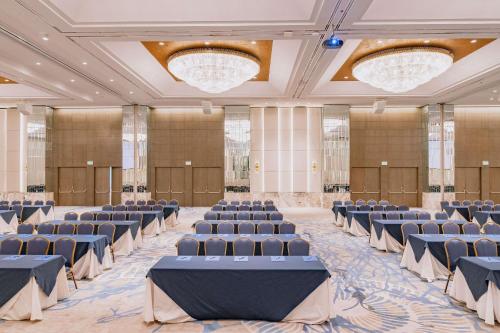 a large room with rows of chairs and chandeliers at Hilton Colon Guayaquil Hotel in Guayaquil