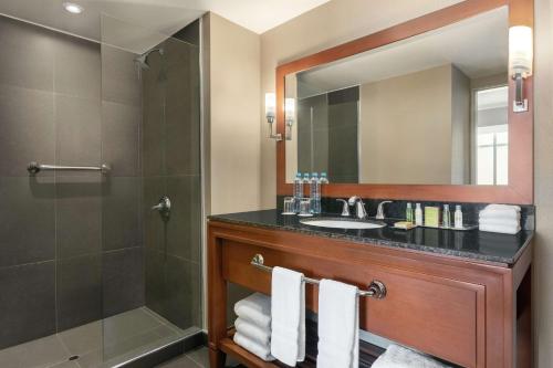 a bathroom with a sink and a shower at DoubleTree by Hilton Lima Miraflores El Pardo in Lima