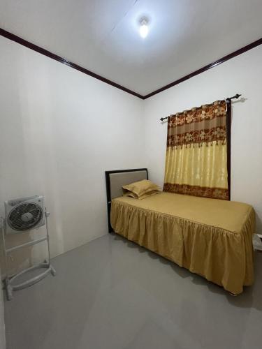 a bedroom with a bed and a window in it at Mawar Homestay in Banda Aceh